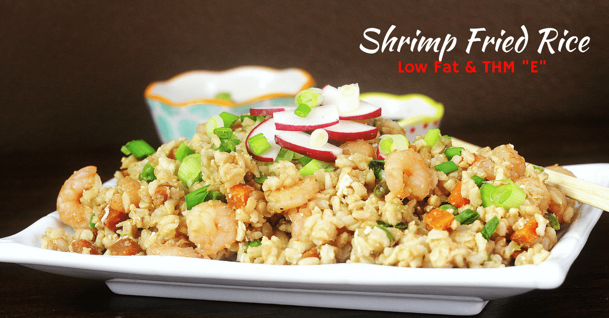 A white platter with shrimp fried rice topped with green onions and sliced radishes on top. 